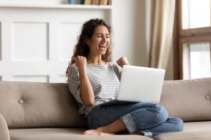 Person celebrating at laptop