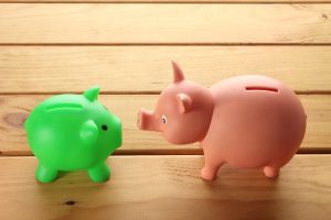 Piggy Banks on Wooden Background